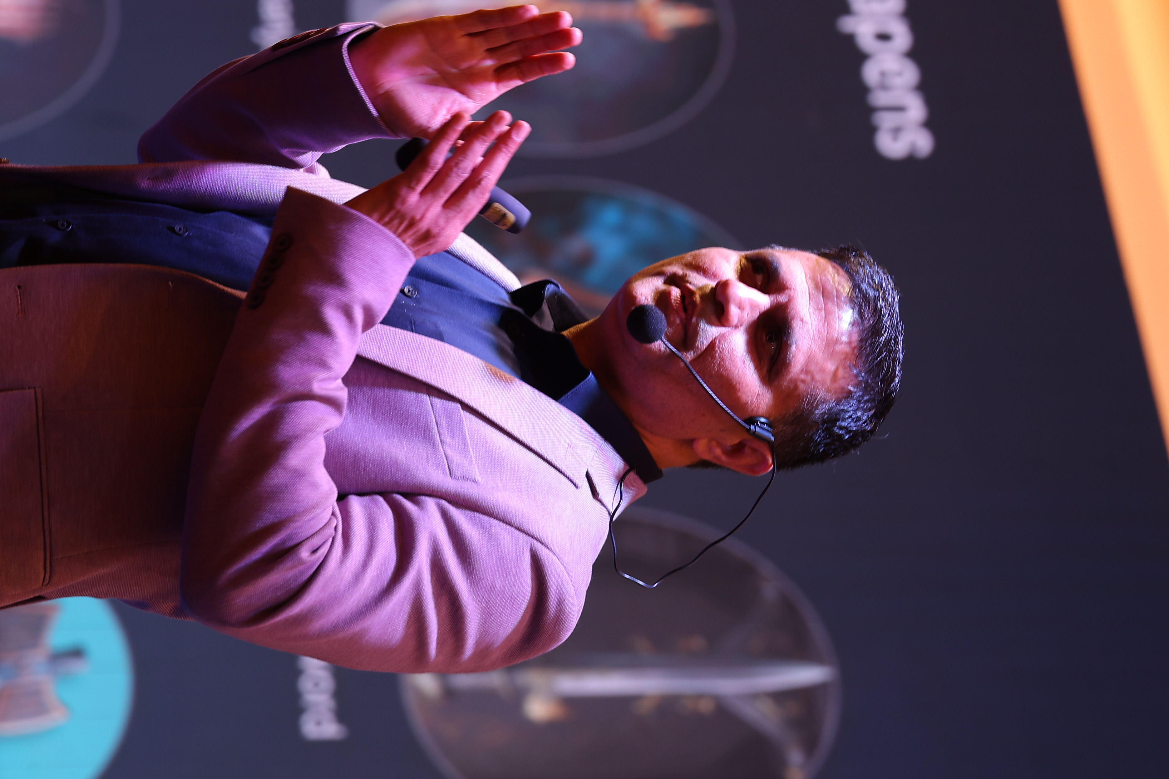 Mahesh Chand speaking on stage